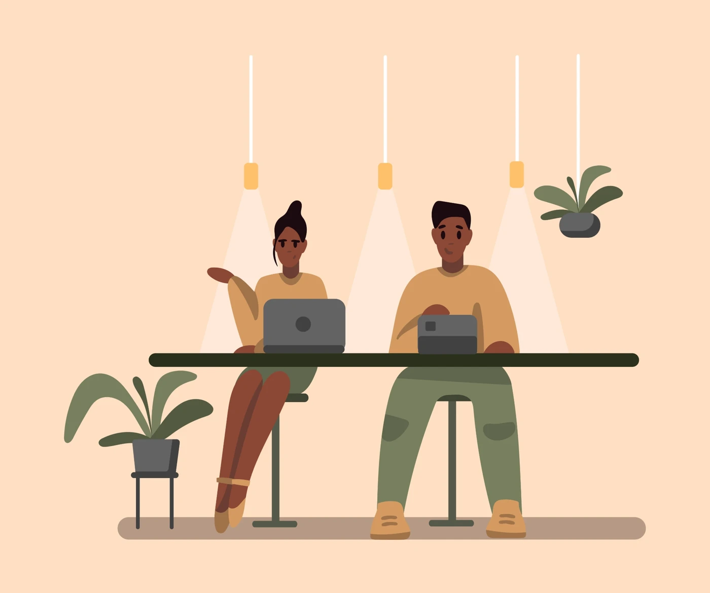 Duas pessoas trabalhando com notebooks no coworking da Elus Lavanderia